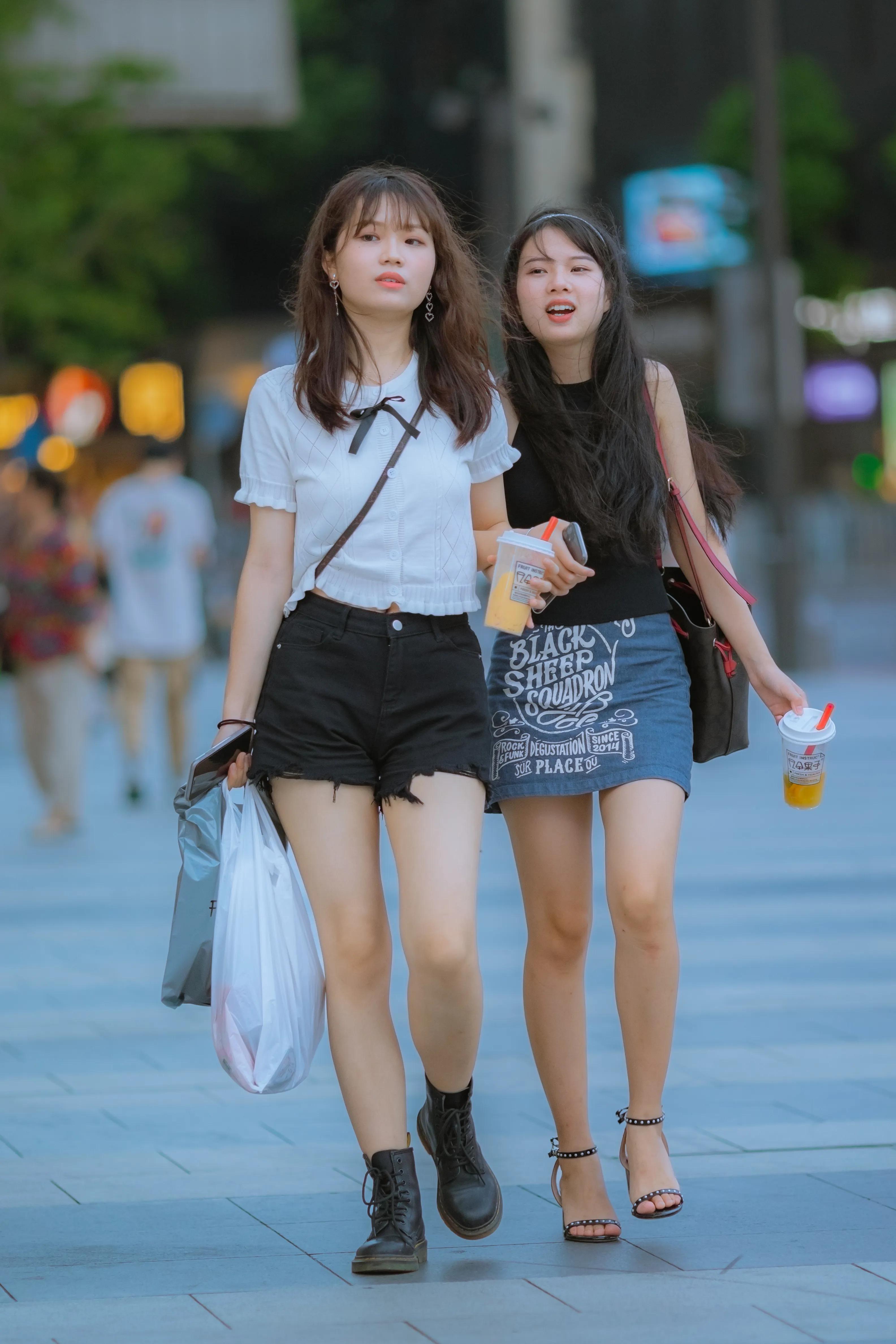 A Pair Of Girls Walking In The Street Clapping Arm In Arm Seems To Have Endless Things To Say Imedia